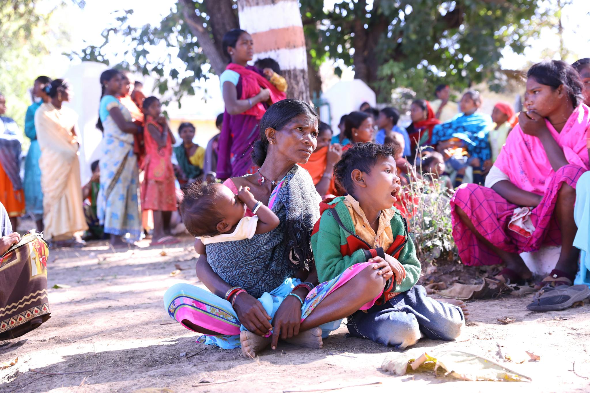 A rural scene depicting a mother and children in Khudiya, India, capturing traditional life.